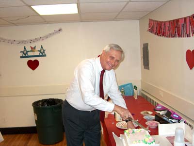 Junior Warden cuts the cake